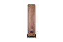 Back of a wooden floor-standing speaker on a white background