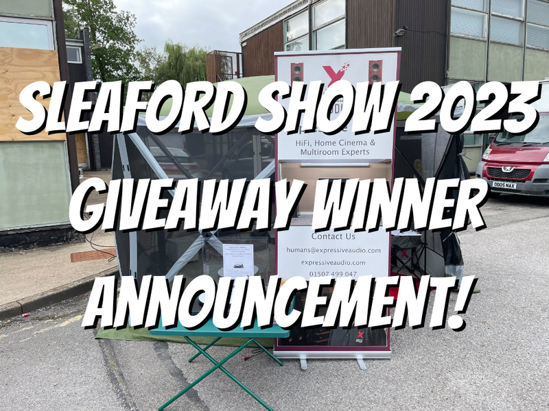 A photo of a gazebo tent with a banner advertising Expressive Audio, with the words "Sleaford Show 2023 Giveaway Winner Announcement" in large, bold white text with a black shadow.