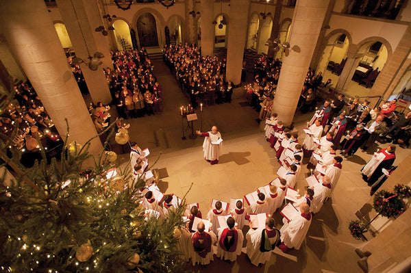 A choir singing in a cathedral at Christmas time, with an audience watching