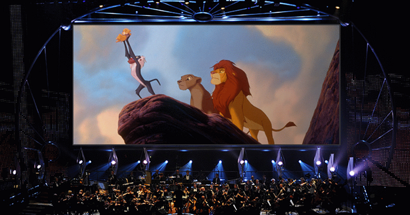A cinema screen showing the scene from "Lion King" where Simba is raised up to the sky