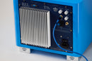 Back of a blue subwoofer with cooling fins and labeled 'REL', with a blue braided cable plugged into it, on a white background